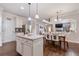 Open-concept kitchen with island, flowing into the dining room and living room at 2307 Loughridge Dr, Buford, GA 30519
