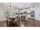 Eat-in kitchen with white cabinets, stainless steel appliances, hardwood floors, and a center island at 2307 Loughridge Dr, Buford, GA 30519