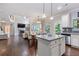 Open-concept kitchen with an island and breakfast bar, flowing into the dining and living areas at 2307 Loughridge Dr, Buford, GA 30519