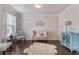 Bright and airy living room features hardwood floors and neutral décor, great for relaxing at 2307 Loughridge Dr, Buford, GA 30519