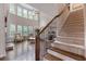 Bright living room featuring hardwood floors, a fireplace, and staircase with wrought iron spindles at 2307 Loughridge Dr, Buford, GA 30519