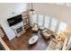 Aerial view of a living room with hardwood floors, fireplace, and large windows at 2307 Loughridge Dr, Buford, GA 30519