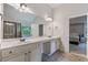 Bright bathroom with double vanity sinks, granite countertop, and access to the Primary bedroom at 2307 Loughridge Dr, Buford, GA 30519