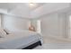 Large main bedroom with a tray ceiling and view into the ensuite bathroom at 2307 Loughridge Dr, Buford, GA 30519