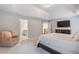 Bright main bedroom featuring an ensuite bathroom, walk-in closet and accent chair at 2307 Loughridge Dr, Buford, GA 30519