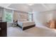Spacious main bedroom with tray ceiling, large windows, and neutral decor at 2307 Loughridge Dr, Buford, GA 30519