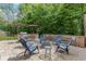 Outdoor patio with stone flooring, dining set, seating area, and a built in grill at 2307 Loughridge Dr, Buford, GA 30519