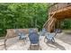 Large backyard patio area with stone floor, stone benches, dining set, and outdoor living space at 2307 Loughridge Dr, Buford, GA 30519