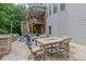 Backyard patio featuring a dining set, lounge chairs, and outdoor kitchen with grill at 2307 Loughridge Dr, Buford, GA 30519