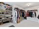 Well-organized walk-in closet with lots of shelving for shoes and hanging clothes at 2307 Loughridge Dr, Buford, GA 30519