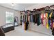Spacious walk-in closet with ample storage, shelving, and natural light from the window at 2307 Loughridge Dr, Buford, GA 30519