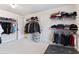 Large walk-in closet with an abundance of storage space and visible carpeting at 2307 Loughridge Dr, Buford, GA 30519
