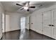 Spacious bedroom with hardwood floors, ceiling fan, large windows, and ample closet space for storage at 2910 Creek Tree Ln, Cumming, GA 30041