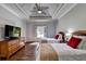 A bedroom with light blue walls, wood floors, and two twin beds with red pillows at 2910 Creek Tree Ln, Cumming, GA 30041