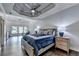 Stunning bedroom with tray ceiling, hardwood floors and chandelier at 2910 Creek Tree Ln, Cumming, GA 30041