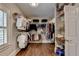 Large walk-in closet with custom shelving, hanging racks, hardwood floors, and a window at 2910 Creek Tree Ln, Cumming, GA 30041