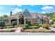 Beautiful clubhouse with manicured landscaping, a brick facade, and ample parking spaces at 2910 Creek Tree Ln, Cumming, GA 30041