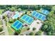 Aerial view of a community featuring swimming pools, tennis courts, clubhouse and parking at 2910 Creek Tree Ln, Cumming, GA 30041