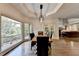 Elegant dining room with hardwood floors, modern lighting, and large windows at 2910 Creek Tree Ln, Cumming, GA 30041