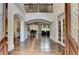 Inviting foyer with hardwood floors, arched doorways, and a view of the open-concept living spaces at 2910 Creek Tree Ln, Cumming, GA 30041