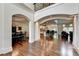 Spacious foyer with arched doorways leading to the dining room, kitchen, and living room at 2910 Creek Tree Ln, Cumming, GA 30041