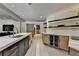 View of modern kitchen with large island, cabinets, wine coolers, and hardwood floors at 2910 Creek Tree Ln, Cumming, GA 30041