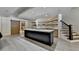 Modern kitchen featuring an island with countertop sink, lighting, and stairs to the side at 2910 Creek Tree Ln, Cumming, GA 30041