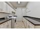 Well-equipped laundry room with modern washer and dryer, granite countertops, and built-in storage cabinets at 2910 Creek Tree Ln, Cumming, GA 30041
