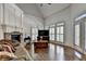 Cozy living room with a stone fireplace, hardwood floors, and large windows at 2910 Creek Tree Ln, Cumming, GA 30041