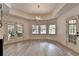 Bright living area with hardwood floors, large windows, and a door to the outdoor patio at 2910 Creek Tree Ln, Cumming, GA 30041