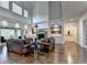 Spacious living room with a stone fireplace, hardwood floors, and large windows overlooking the backyard at 2910 Creek Tree Ln, Cumming, GA 30041