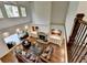 Aerial view of the living room showcasing the fireplace, hardwood floors, and furniture at 2910 Creek Tree Ln, Cumming, GA 30041