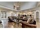 Spacious living room features hardwood floors, high ceilings, and leather sofas at 2910 Creek Tree Ln, Cumming, GA 30041