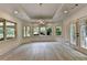 Bright living area with hardwood floors, large windows, and a door to the outdoor patio at 2910 Creek Tree Ln, Cumming, GA 30041