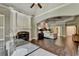 Spacious main bedroom featuring a fireplace, hardwood floors, tray ceiling, and an arched entryway at 2910 Creek Tree Ln, Cumming, GA 30041