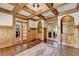 Elegant office with custom wood paneling, built-in shelving, and a decorative rug on hardwood floors at 2910 Creek Tree Ln, Cumming, GA 30041