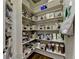 Organized walk-in pantry with custom shelving, providing ample storage for all your groceries and supplies at 2910 Creek Tree Ln, Cumming, GA 30041