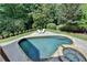 Inviting pool and spa surrounded by lush landscaping, perfect for outdoor relaxation and entertaining at 2910 Creek Tree Ln, Cumming, GA 30041