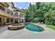 Stunning pool with a stone-lined hot tub and lush landscaping in a private backyard setting at 2910 Creek Tree Ln, Cumming, GA 30041
