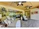 Relaxing porch with ceiling fan and outdoor seating area, offering a tranquil view of lush greenery at 2910 Creek Tree Ln, Cumming, GA 30041