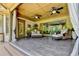 Relaxing porch with ceiling fan and outdoor seating area, offering a tranquil view of lush greenery at 2910 Creek Tree Ln, Cumming, GA 30041