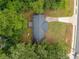 An aerial view of a house with a dark gray roof surrounded by green trees and a long driveway at 8535 Hiram Acworth Hwy, Dallas, GA 30157
