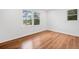Bright bedroom with wood flooring, fresh paint, and natural light from two windows at 8535 Hiram Acworth Hwy, Dallas, GA 30157
