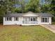 Charming renovated ranch-style home featuring a welcoming front porch and a freshly painted white brick facade at 8535 Hiram Acworth Hwy, Dallas, GA 30157