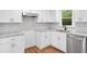 Modern kitchen with white cabinetry, granite countertops, tile backsplash, and stainless steel appliances at 8535 Hiram Acworth Hwy, Dallas, GA 30157