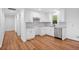 Bright kitchen with granite countertops, white cabinets, stainless steel appliances, and wood flooring at 8535 Hiram Acworth Hwy, Dallas, GA 30157