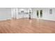 Open concept living space with hardwood floors connecting the living room, kitchen, and dining areas at 8535 Hiram Acworth Hwy, Dallas, GA 30157