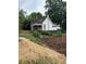 Exterior view of home featuring white siding, a front porch and a well treed yard at 1103 Windsor St, Atlanta, GA 30310