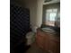 Standard bathroom featuring a vanity with sink, toilet, and shower with curtain at 14104 Fairington Circle Ridge, Stonecrest, GA 30038