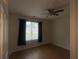 Bedroom features wood-look floors, natural light, and a ceiling fan at 14104 Fairington Circle Ridge, Stonecrest, GA 30038